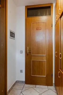 a wooden door in a room next to a wall at Apartments Mija in Krotica