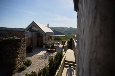 a man walking down the stairs of a building at Vila Mravljevi Weinderer in Preserje