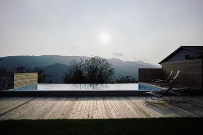 a swimming pool with a view of the mountains at Vila Mravljevi Weinderer in Preserje