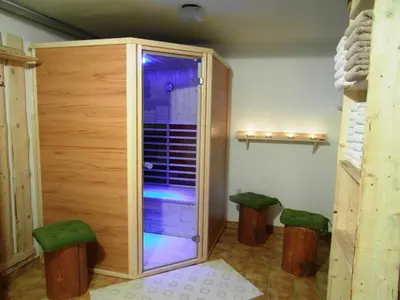 a sauna with two green stools in a room at Turistična kmetija Košir in Kranjska Gora