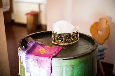 a hat is sitting on top of a barrel at Turistična kmetija Košir in Kranjska Gora