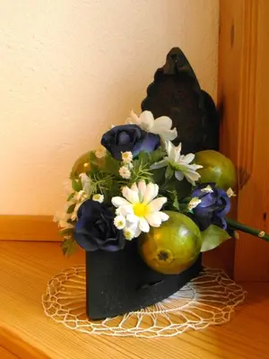 a vase filled with flowers on a table at Turistična kmetija Košir in Kranjska Gora