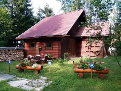 a log cabin with flowers in front of it at Turistična kmetija Košir in Kranjska Gora