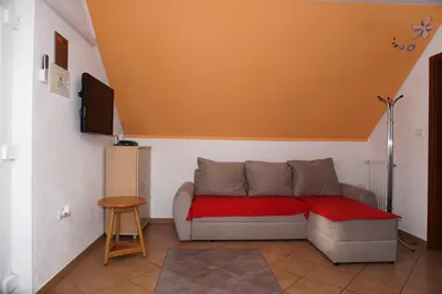 a living room with a couch and a flat screen tv at Apartment Ozebek in Cerkno