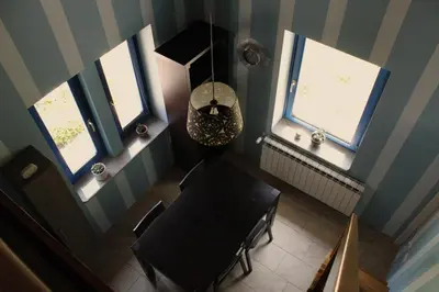 an overhead view of a dining room with a table and windows at Apartment Dandelion in Branik
