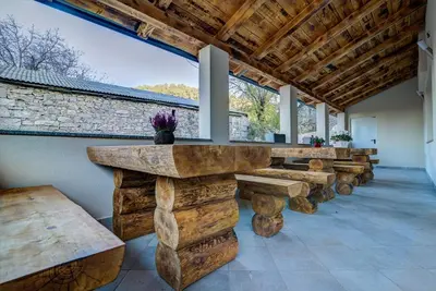 a large room with wooden tables and benches at Dobra Hiša Zdravja Čičarija in Golac