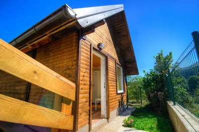 a log cabin with a sliding glass door at Dobra Hiša Zdravja Čičarija in Golac