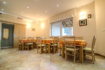 a dining room with a table and chairs at Dobra Hiša Zdravja Čičarija in Golac