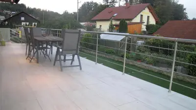 a balcony with a table and chairs and a fence at Dom Vita Sticna in Ivančna Gorica
