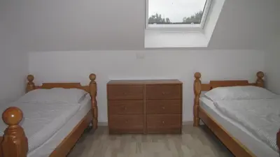 two twin beds in a bedroom with a window at Dom Vita Sticna in Ivančna Gorica
