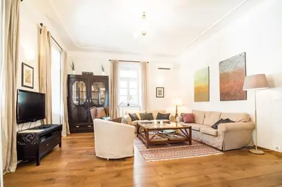 a living room with a couch and a table at Stylish Penthouse with large terrace in Most na Soči