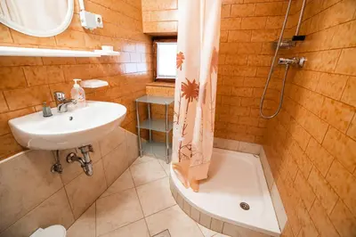 a bathroom with a sink and a shower and a tub at Farm Stay Žagar in Mozirje