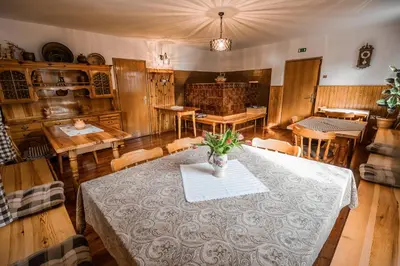 a dining room with a table with a vase on it at Farm Stay Žagar in Mozirje