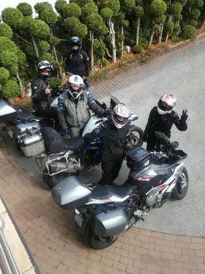 a group of motorcyclists standing next to their motorcycles at Angel's Nest Apartment in Komenda