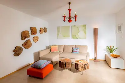 a living room with a couch and a table at Angel's Nest Apartment in Komenda
