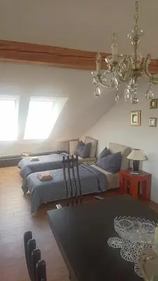a bedroom with a bed and a couch at Angel's Nest Apartment in Komenda