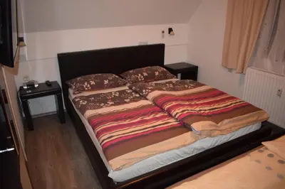 a large bed in a small room with at Apartment Borovnica in Moravske Toplice