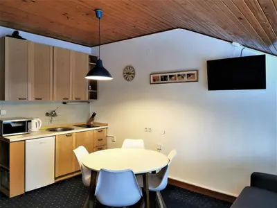 a kitchen with a table and chairs in a room at Apartma Svizec Rogla in Zreče