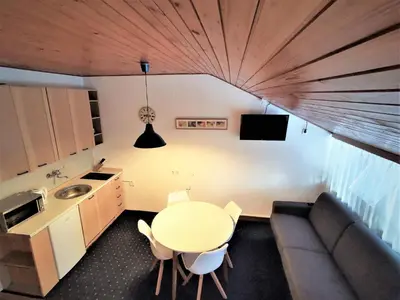 a living room with a table and a couch at Apartma Svizec Rogla in Zreče