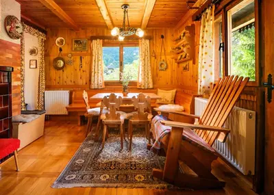 a dining room with a table and chairs at Chalet Romantic in Zgornje Jezersko