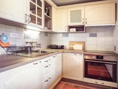 a kitchen with white cabinets and a sink at Chalet Romantic in Zgornje Jezersko