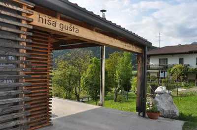 a wooden shed with a sign that reads hissega guest at Holiday Home Hisa Gusta in Most na Soči