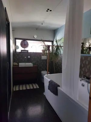 a bathroom with a bath tub and a sink at Holiday Home Hisa Gusta in Most na Soči
