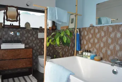 a bathroom with a tub and a sink at Holiday Home Hisa Gusta in Most na Soči