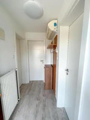 an empty hallway with a white door and a room at Apartments Sole in Podčetrtek