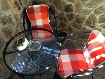 a table and two chairs with a glass at Apartment CDR in Zreče