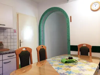 a dining room with a table and two chairs at Apartment CDR in Zreče