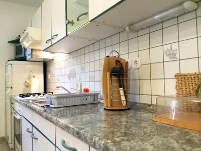 a kitchen with a counter top with a stove top oven at Apartment CDR in Zreče