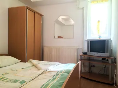 a bedroom with a bed and a tv on a table at Apartment CDR in Zreče
