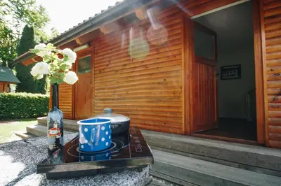 a house with a table with a pot on it at Počitniška hiška Pod Skalco in Kamnik