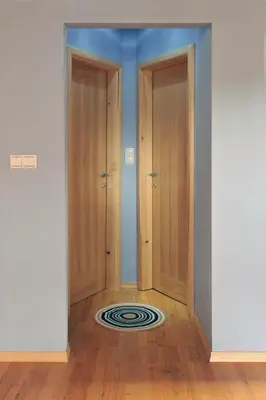 an empty room with two doors and a rug at Apartment Šilec in Šmarje pri Jelšah