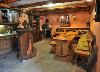 a large kitchen with a wooden table and a counter at Apartment Šilec in Šmarje pri Jelšah