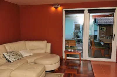 a living room with a couch and a table at Apartment Šilec in Šmarje pri Jelšah