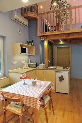 a kitchen with a table and chairs in a room at Apartment Šilec in Šmarje pri Jelšah