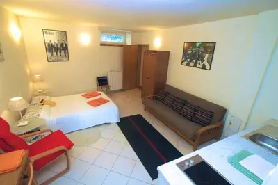 a hotel room with a bed and a couch at Chalet Floranneve in Bovec