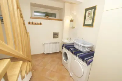 a bathroom with a washing machine and a sink at Chalet Floranneve in Bovec