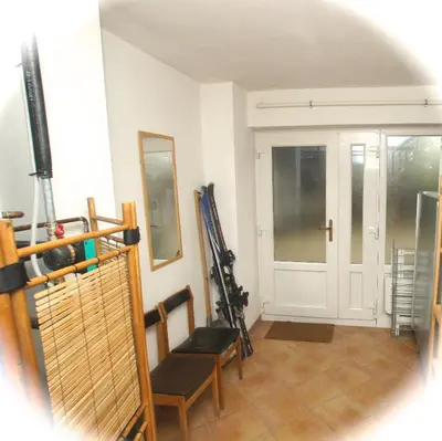 a room with a door and a chair and some skis at Chalet Floranneve in Bovec