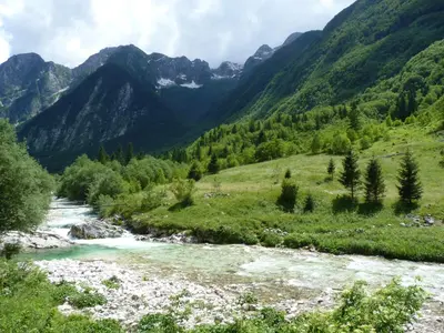 a river in a valley with mountains in the background at Chalet Floranneve in Bovec