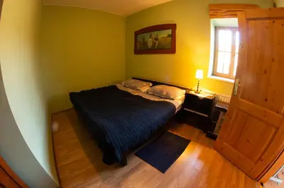 a small bedroom with a bed and a window at Turistična kmetija Vrezner Apartment in Zgornja Kungota