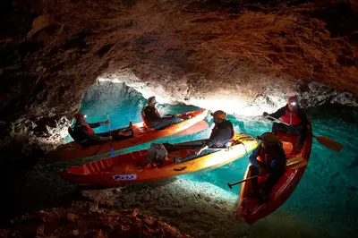 a group of people in canoes in a cave at Apartmaji Koželj in Ribnica na Pohorju