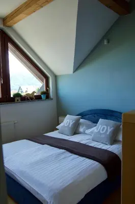 a bedroom with two beds and a window at Rudi Hiti's Guest House in Bled
