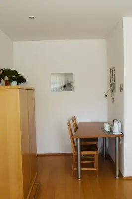 a dining room with a table and two chairs at Rudi Hiti's Guest House in Bled