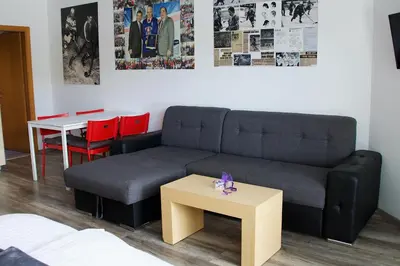 a living room with a couch and a table at Rudi Hiti's Guest House in Bled