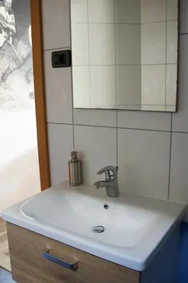 a sink in a bathroom with a mirror at Rudi Hiti's Guest House in Bled
