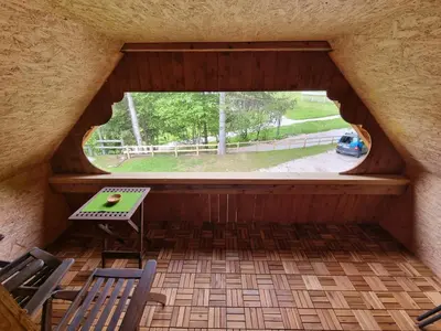 a view of a porch with a table and chairs at Lodge In Koprivnik in Koprivnik v Bohinju
