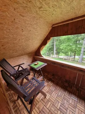 a room with a table and a chair and a window at Lodge In Koprivnik in Koprivnik v Bohinju